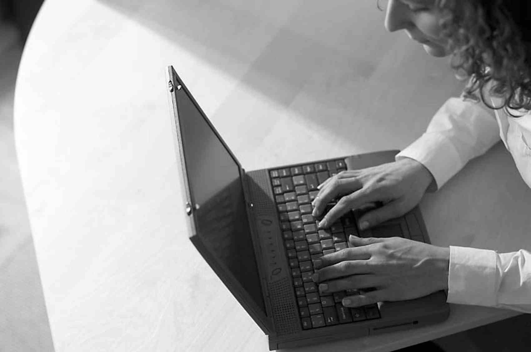Caucasian businesswoman typing on black laptop computer.jpg