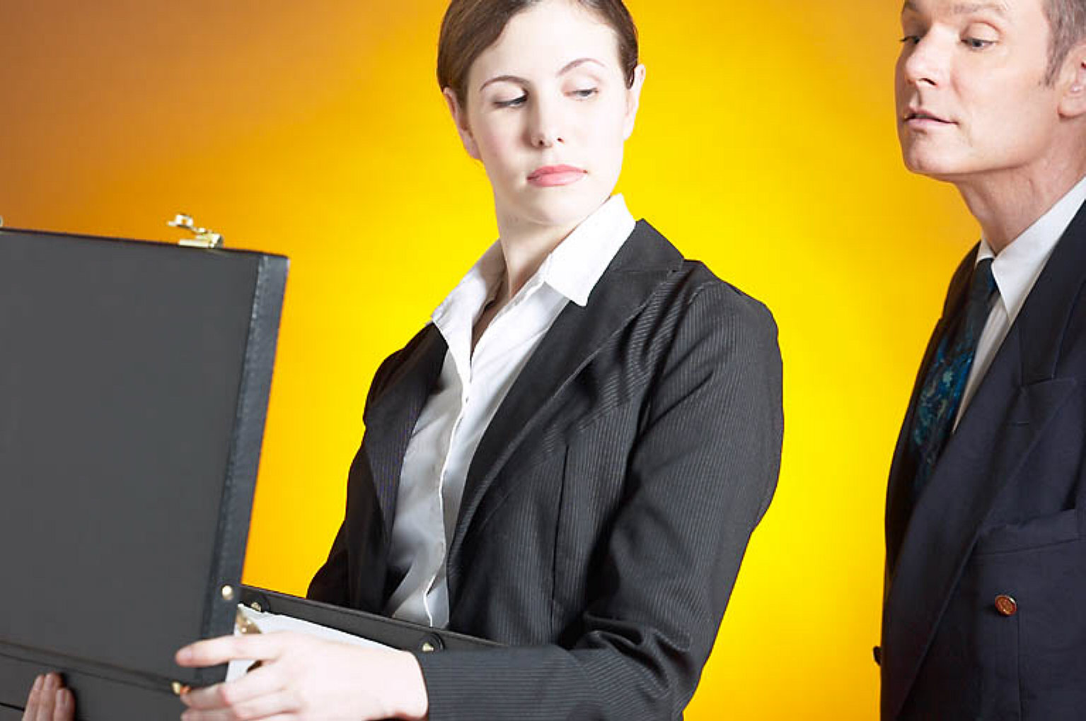 Man spying into woman briefcase.jpg